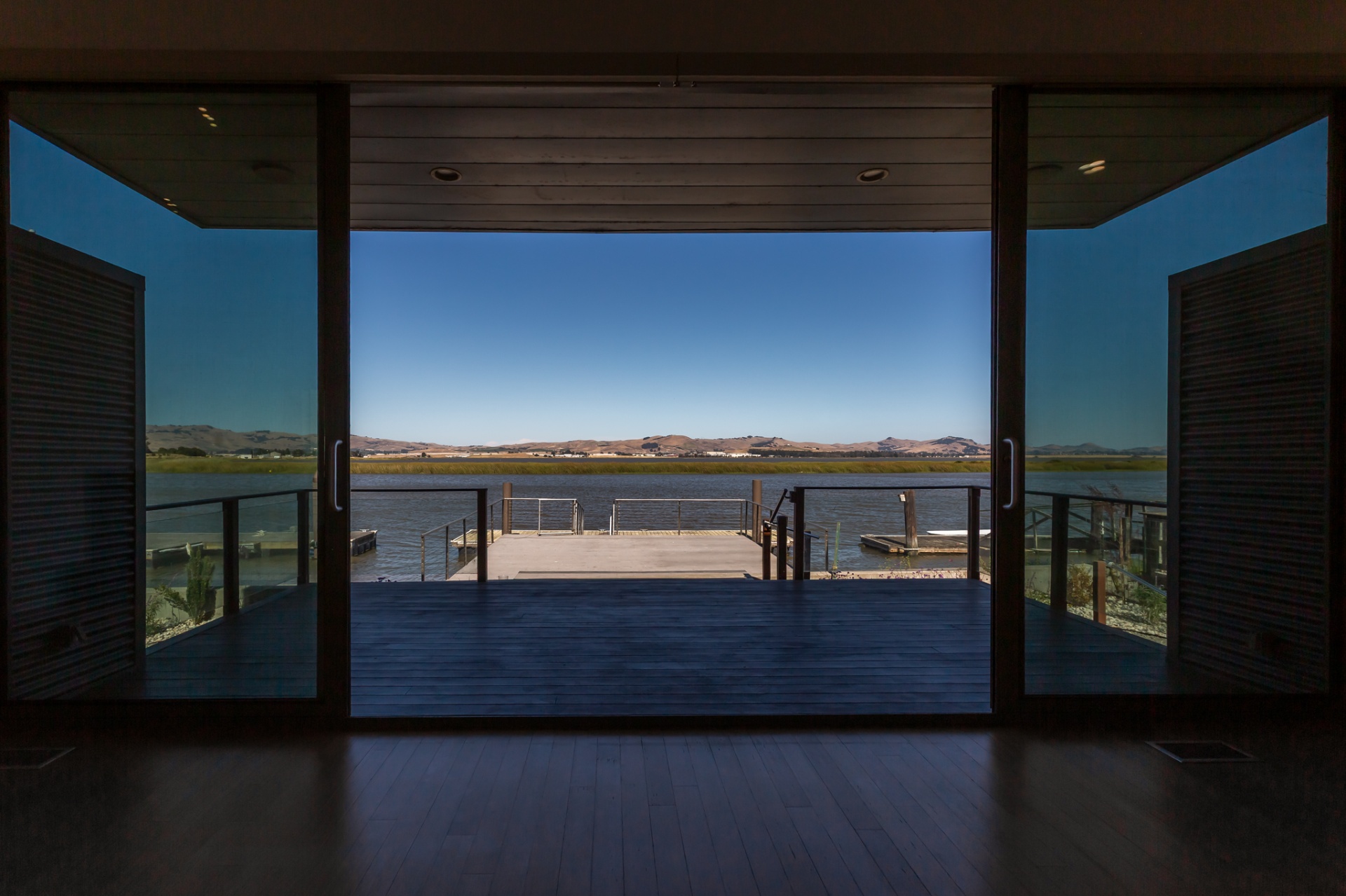 View through the sliding doors toward the deck and private dock