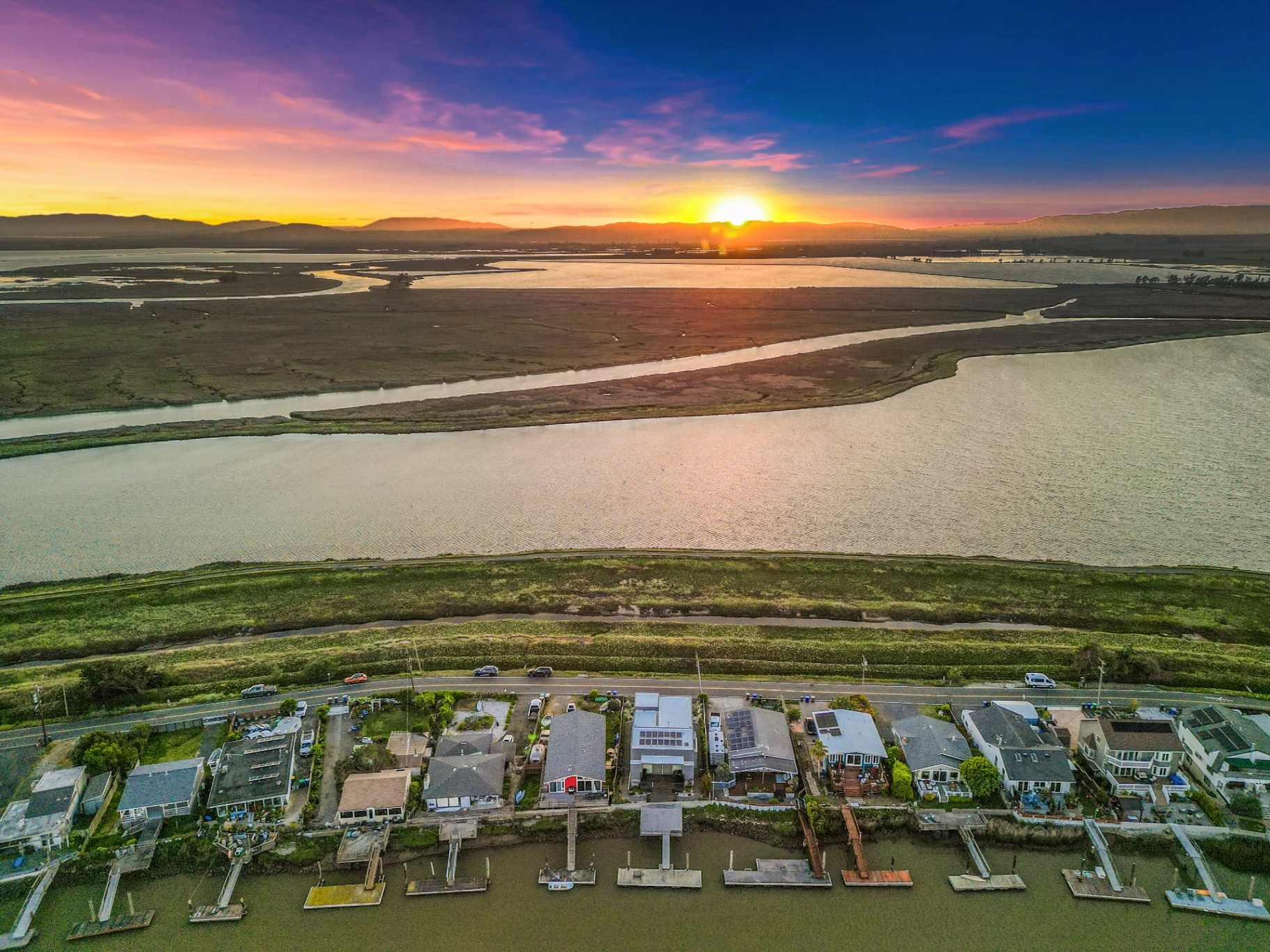 Golden hour aerial of the waterfront neighborhood and surrounding waterways